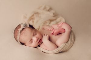 Adelaide newborn baby photographer's photo of a newborn baby on a cream backdrop.