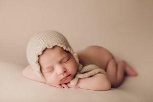 Adelaide newborn baby photographer's photo of a newborn baby on a cream backdrop.