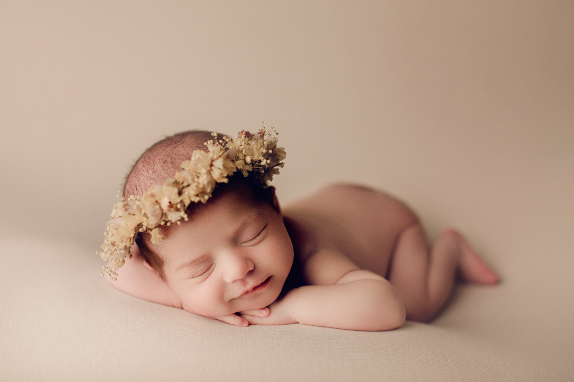 Adelaide newborn baby photographer's photo of a newborn baby on a cream backdrop.
