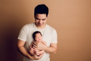 Adelaide newborn baby photographer's photo of a newborn baby girl with her dad.
