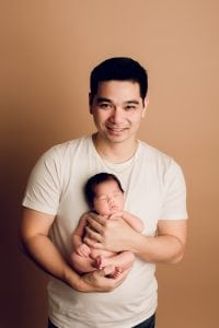 Adelaide newborn baby photographer's photo of a newborn baby girl with her dad.