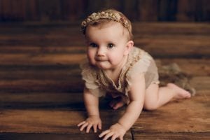 Adelaide baby photographers photo of a 9 month old baby girl sitting.