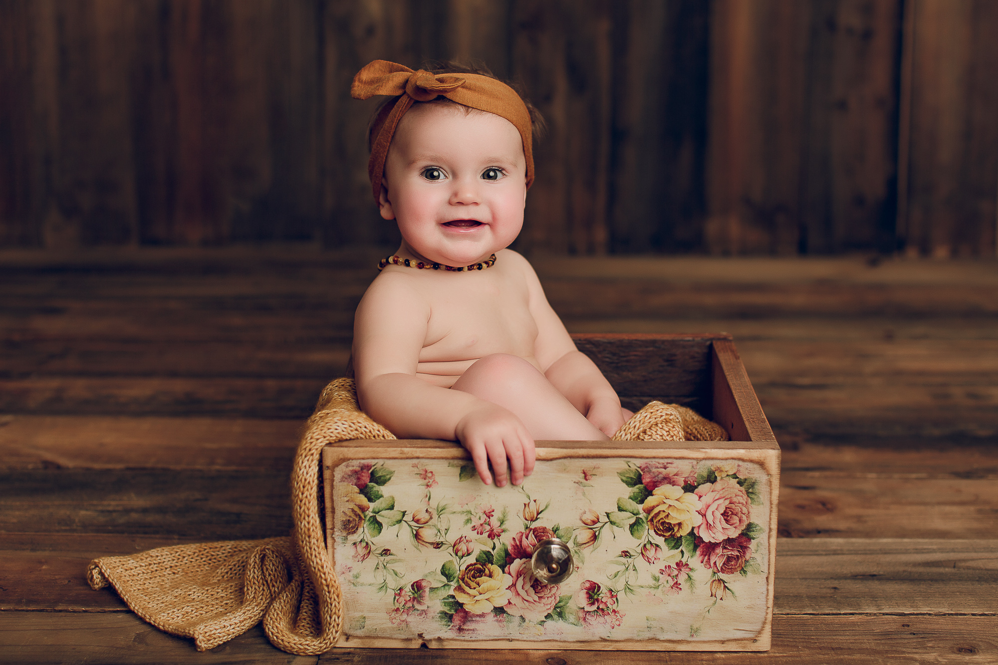 Adelaide baby photographers photo of a 9 month old baby girl sitting.