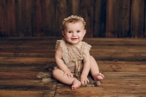 Adelaide baby photographers photo of a 9 month old baby girl sitting.