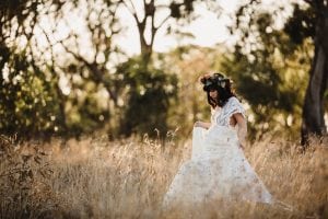 Adelaide maternity photograph of a pregnant woman in a white lace dress.