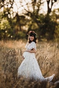 Adelaide maternity photograph of a pregnant woman in a white lace dress.