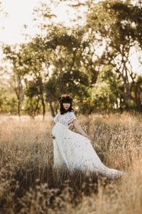 Adelaide maternity photograph of a pregnant woman in a white lace dress.