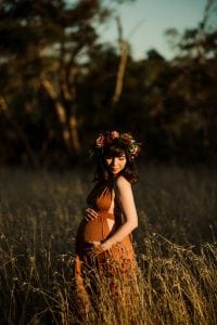Adelaide maternity photograph of a pregnant mother in a rust coloured dress.