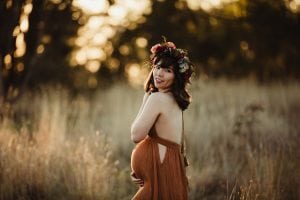 Adelaide maternity photograph of a pregnant mother in a rust coloured dress.