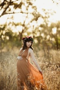 Adelaide maternity photograph of a pregnant mother in a rust coloured dress.