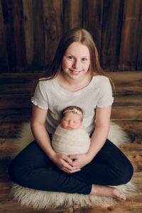 Adelaide newborn baby photographer's photo of a newborn baby girl and her sister.