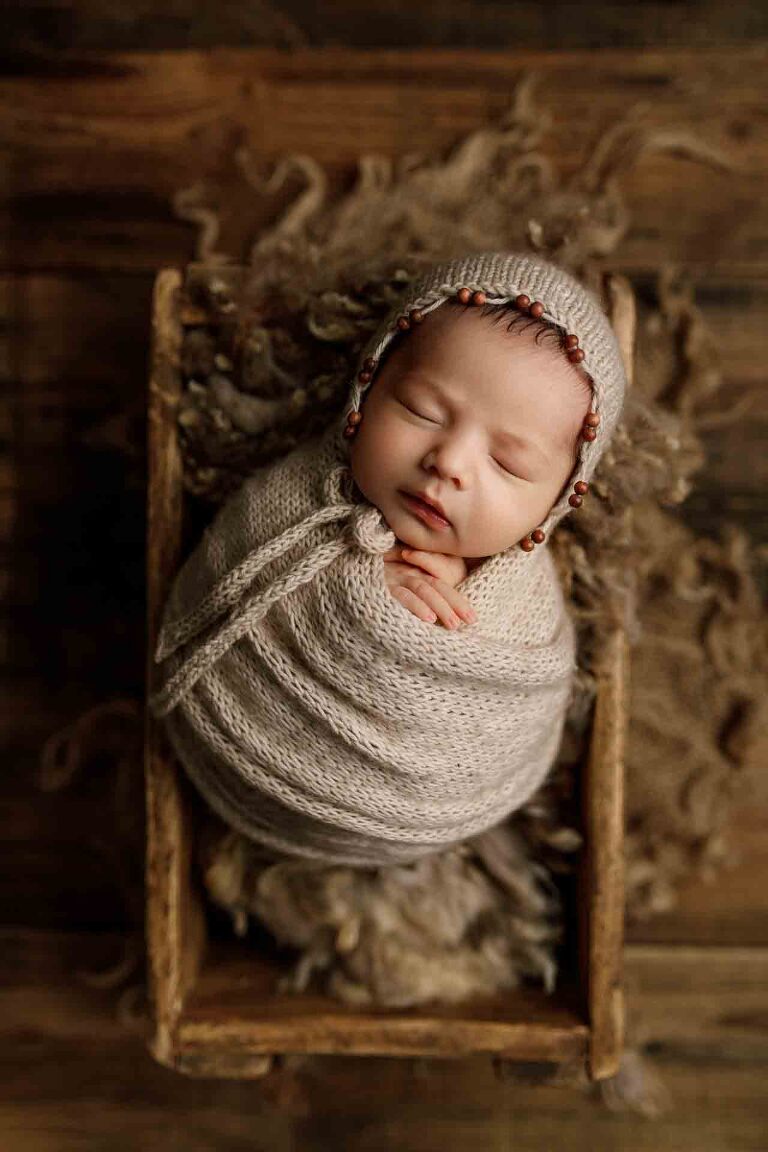 Adelaide newborn baby photographer's photo of a newborn baby boy wrapped up in a crate