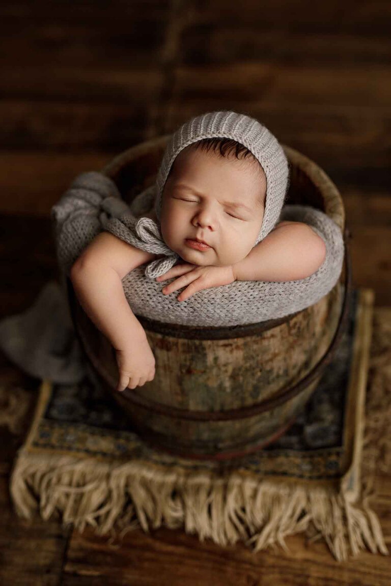Adelaide newborn baby photographer's photo of a newborn baby boy in a bucket.