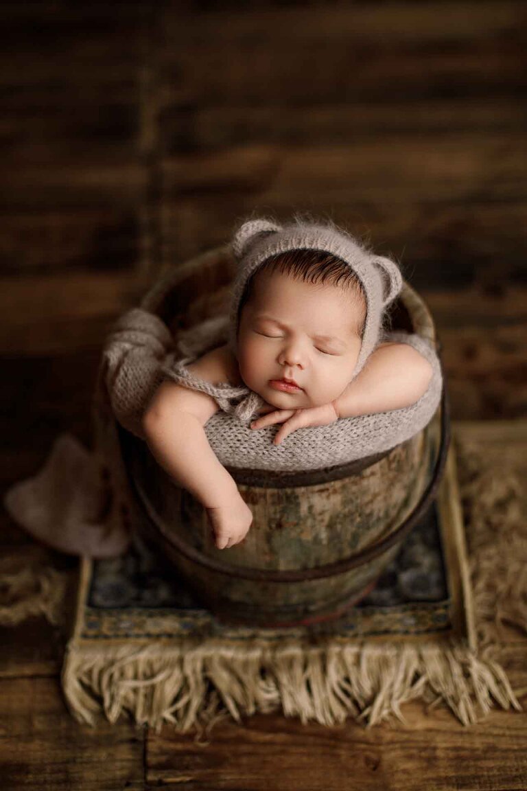 Adelaide newborn baby photographer's photo of a newborn baby boy in a bucket.