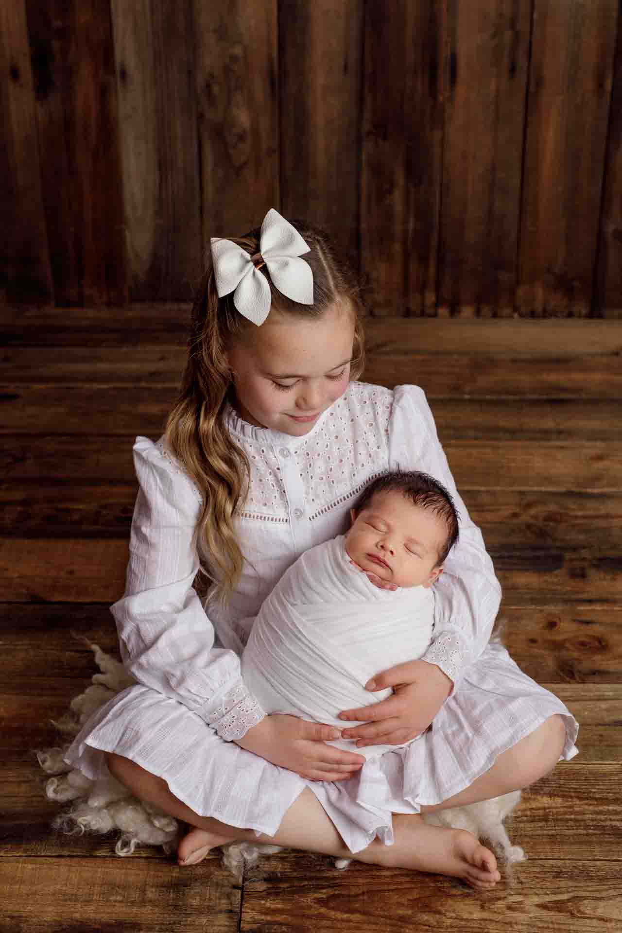 Adelaide newborn baby photographer's photo of a newborn baby boy and hi sibling.
