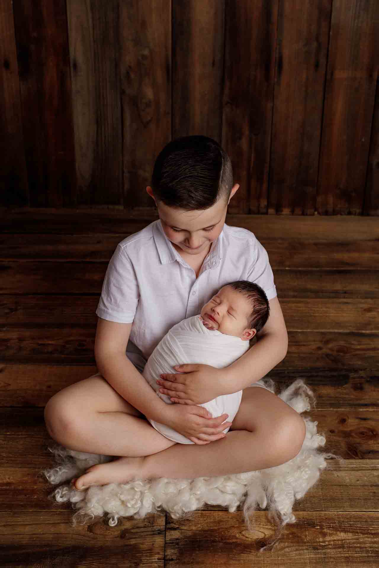 Adelaide newborn baby photographer's photo of a newborn baby boy and hi sibling.