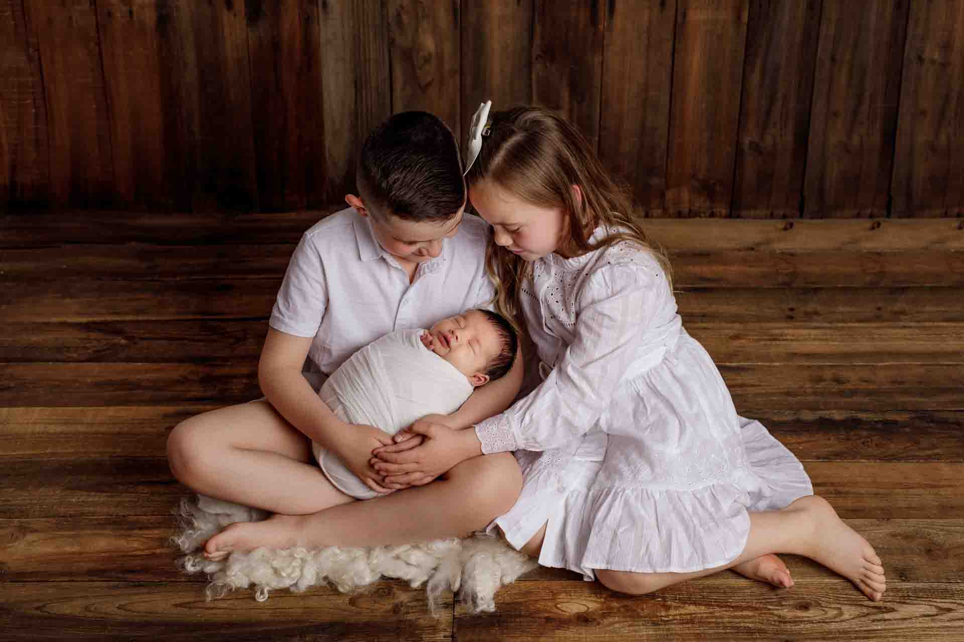 Adelaide newborn baby photographer's photo of a newborn baby boy and hi sibling.