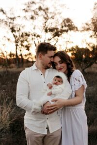 An Adelaide mum and dad with their newborn baby at an outdoor photography session.