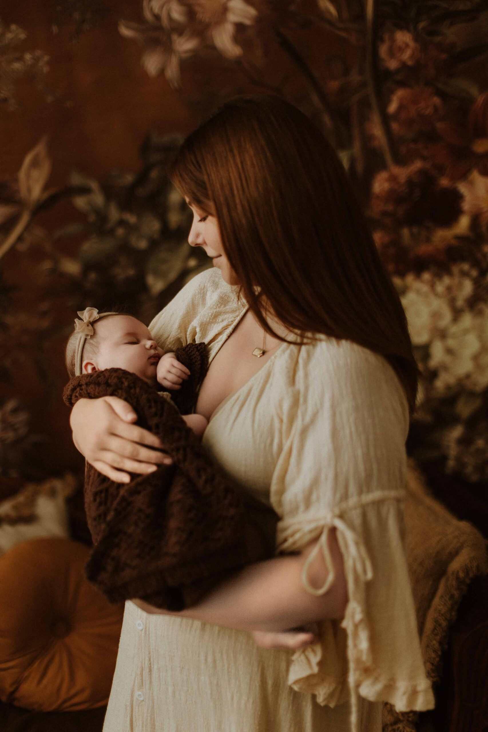 A mum cuddling with her 12 week old baby girl in an Adelaide newborn studio.