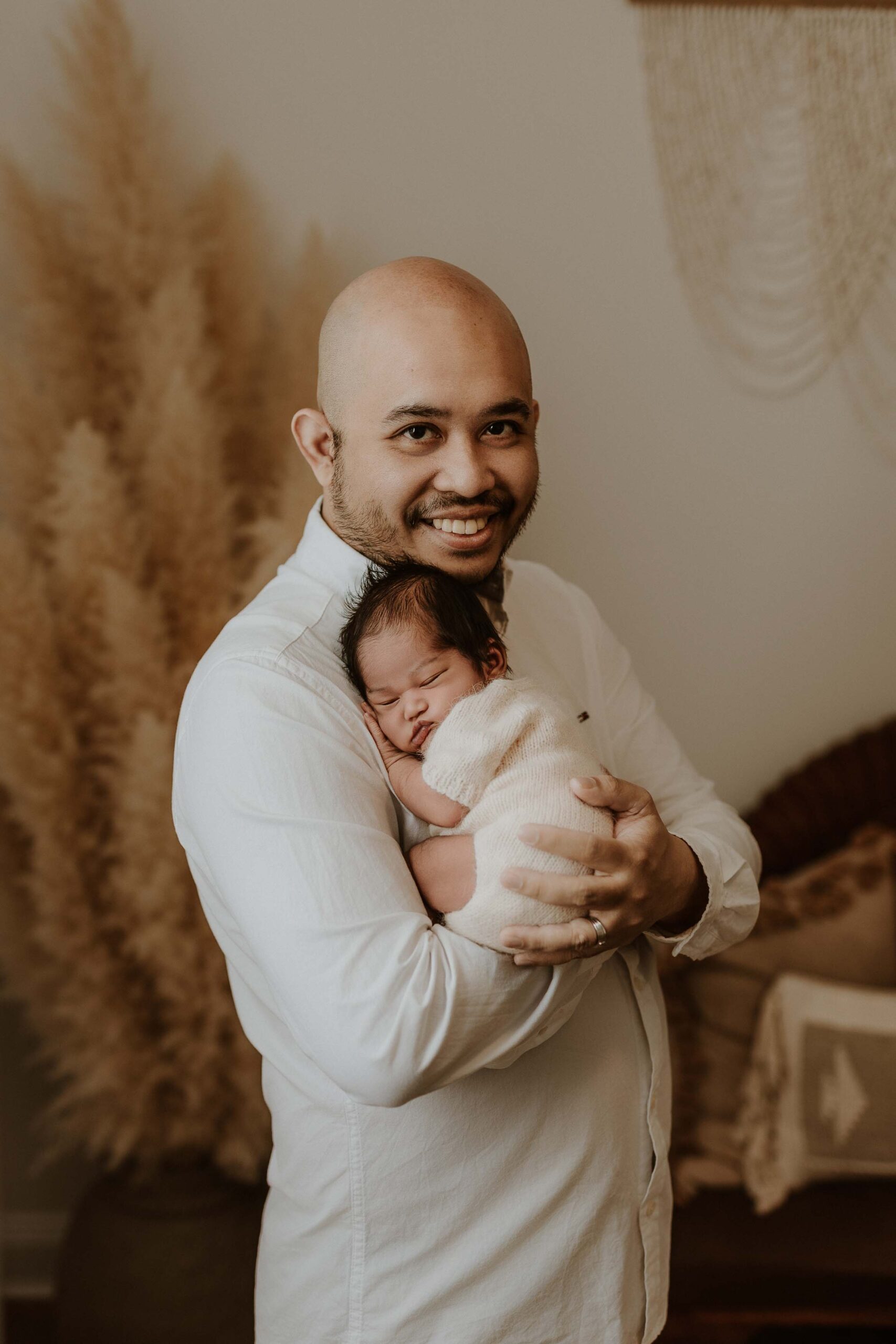 An Adelaide dad holding his baby.
