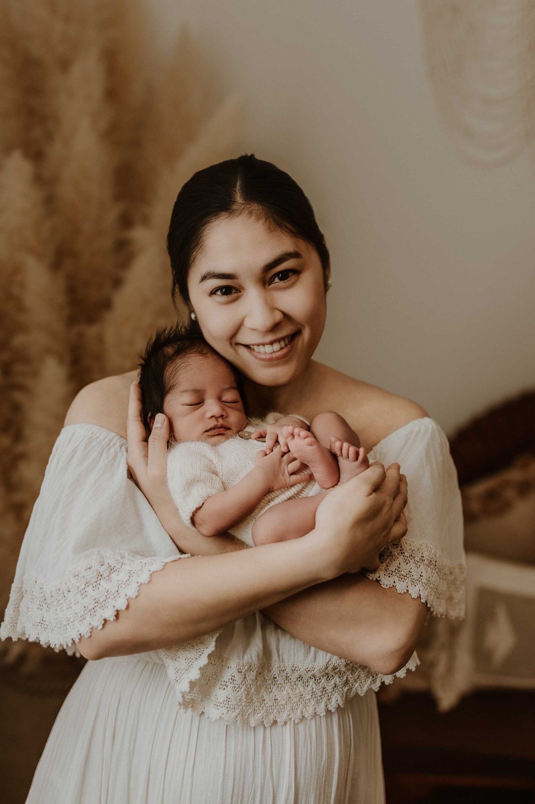 An Adelaide mum holding her newborn baby on her chest.